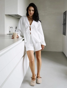 Detail of white two-piece loungewear set with tie-front top and textured fabric