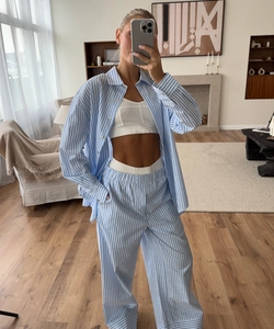Detail of blue and white striped pajama set with long-sleeved shirt and elastic trousers
