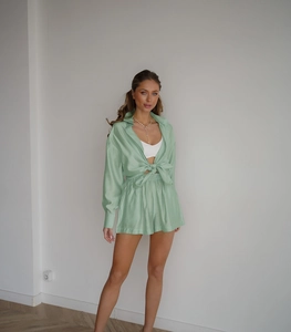 Detail of mint green tencel lounge set with button-down shirt and elastic shorts