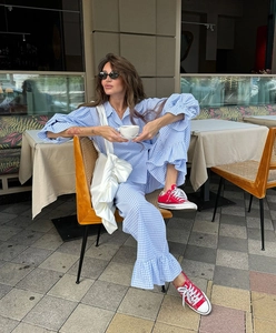 Detailed view of blue gingham lounge set with ruffle cuffs and relaxed collar style