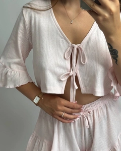 Detail of pink pointelle knit loungewear set with tie-front top and ruffle trim