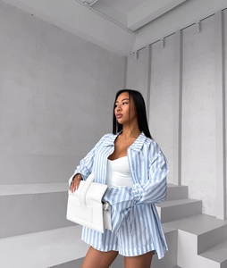 Detail of blue and white vertical striped casual long-sleeved shirt and matching shorts set
