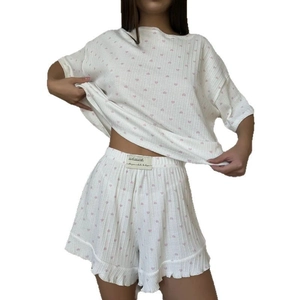 Women white knit pajama set with pink heart print short sleeves and ruffled shorts