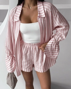 Detail of pink and white striped pajama set with long-sleeve shirt and matching shorts