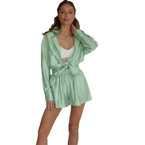 Mint green satin pajama set with long sleeve button down shirt and high waist shorts