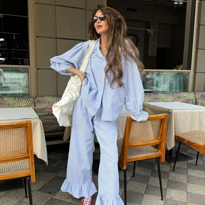 Women's blue gingham loungewear set with puff sleeves and ruffle hem detail
