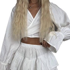 White two-piece set with ruffle long-sleeve crop top and layered mini skirt