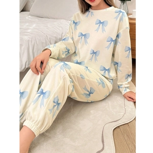 Ensemble pyjama femme comprenant haut à manches longues beige et pantalon à nœuds bleus