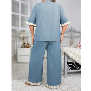 Back view of women's oversized blue pleated loungewear set with white ruffle trim