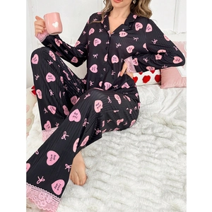 Detail of black pajama set with pink lace trim and heart prints on ribbed fabric