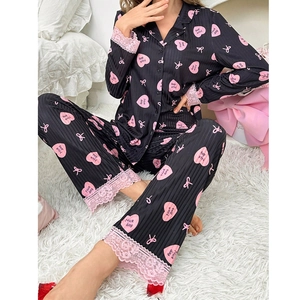 Women's two-piece heart print pajamas set with pink lace trim in black satin fabric