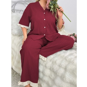 Detail of burgundy lounge set featuring textured fabric and delicate white ruffle trim