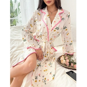 Close-up of floral print sleepwear detail with pink wavy trim and textured fabric