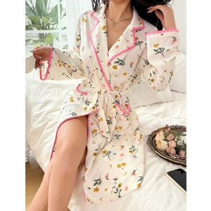 Detailed view of floral long-sleeve bathrobe with pink trim and matching waist tie