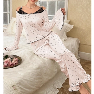 Lace-trimmed pink polka dot pajamas featuring off-shoulder top and ruffled cuffs