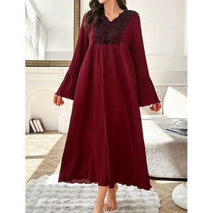 Detail of burgundy lace nightgown featuring floral embroidery and elegant bell sleeves