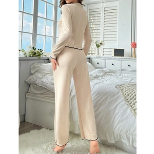 Chic beige ribbed knit pajamas set with black lettuce edge trim and long pants