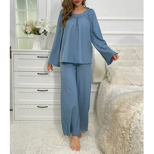 Detail of grey-blue lounge set showing the micro-crinkle knit texture and bell sleeves