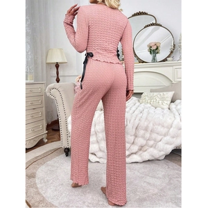 Pink textured pajama set with bow detail and wide-leg pants for women lounging