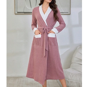 Detail of pink ribbed knit bathrobe showing white contrast trim and side pockets texture