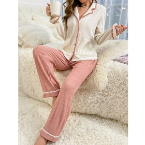 Women's two-piece cream and pink loungewear set with wavy trim and button-up top