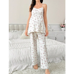 Detail of sweet floral pajama set with delicate white lace trim on cuffs and hemline