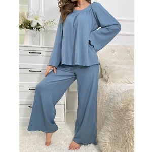 Close-up of light blue ribbed lounge set showing elastic fabric texture and lettuce edge hem