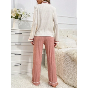 Women's pajama set featuring cream long-sleeve top and pink pants with textured fabric