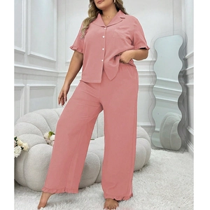 Pink women's pajama set featuring short sleeve button top with elegant ruffle hem details