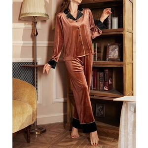 Elegant rust red velvet pajama set with contrast black trim and button-down front