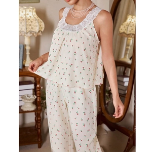 Close-up of lace patchwork neckline on floral print pajama set with beige crepe fabric