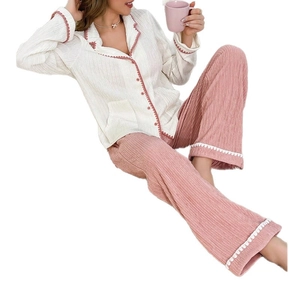 Women's two-piece pajama set with cream scalloped top and pink textured lounge pants
