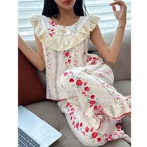 Close-up of floral pajama set featuring delicate lace trim and red rose patterns