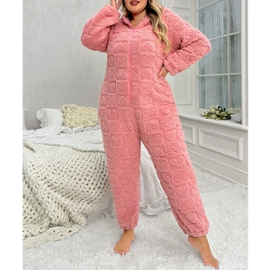Detail of pink fleece jumpsuit with embossed heart pattern and front zipper closure