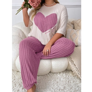 Women's two-piece heart print pajamas set with cream top and pink wide-leg pants