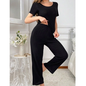 Women's backless black ribbed knit two-piece pajama set with short sleeves and pants
