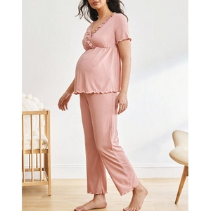 Detail view of the lace trim and ribbed texture on this pink maternity pajama set