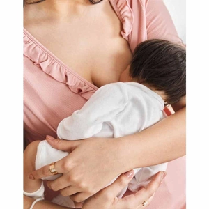 Close-up of nursing top with ribbed texture and ruffle trim for breastfeeding mothers