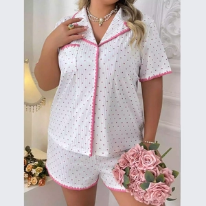 Close-up of pink heart print pajama set with delicate scalloped wavy trim and button details