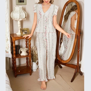 Floral pajama set detail with lace V-neck and ruffled hem in vintage cottagecore style
