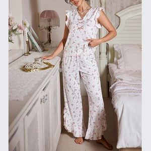 Detail of floral V-neck pajama set with pink bows and delicate ruffle edges