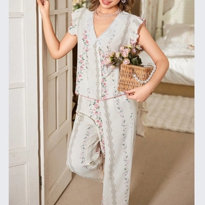 Detail of V-neck lace neckline and pink floral print on cream women's pajama set