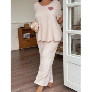Women's pink loungewear set with soft rib-knit fabric, heart detail, and pajama pants