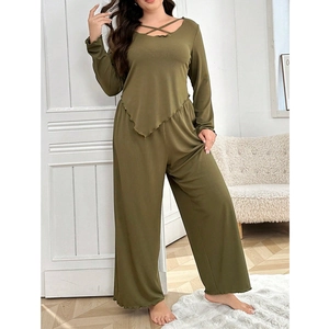 Detail of olive green lounge set showing the crisscross neckline and ribbed fabric texture