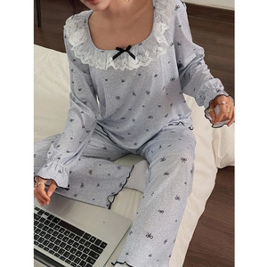 Detail of sweet grey lace pajamas with bow print on soft ribbed fabric texture