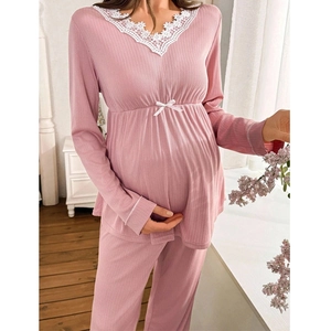 Detail of pink maternity pajamas with lace V-neck and ribbed texture for pregnancy