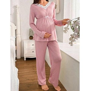 Pink maternity pajama set with V-neck lace trim and pleated high-waisted ribbed knit design