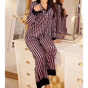 Detailed view of striped satin pajamas with black velvet trim on sleeves and collar