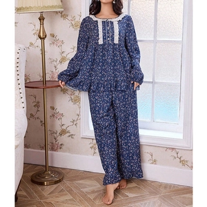 Detail of floral women pajamas with white lace trim and decorative buttons on the chest