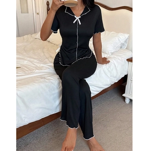 Women's black short sleeve pajama set with white wavy trim and decorative bows
